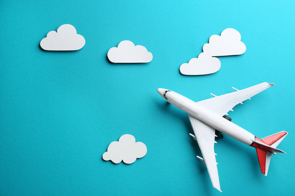 Toy airplane and clouds on light blue background, flat lay - Φωτογραφία, εικόνα