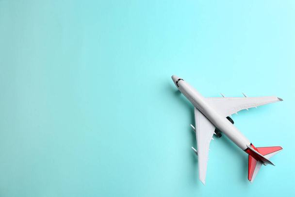Toy airplane on light blue background, top view. Space for text - Foto, imagen
