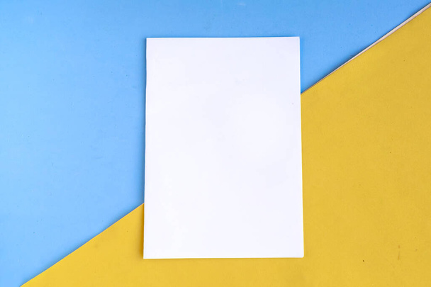 Bílý mockup prázdný na geometrické modré a žluté pozadí, kopírovat prostor pro text - Fotografie, Obrázek