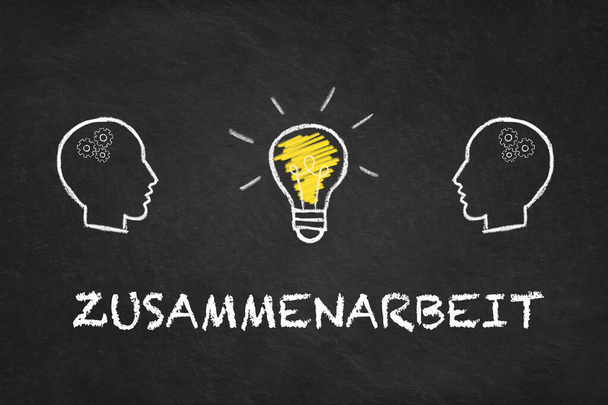 "Zusammenarbeit" text, heads and light bulb on a black chalkboard background. Translation: "Cooperation"  - Photo, Image