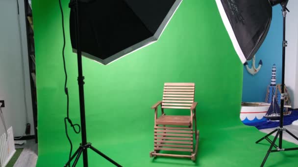 Foto- oder Videostudio mit zwei sechseckigen Studioleuchten. Green Screen und Schaukelstuhl - Filmmaterial, Video