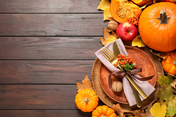 Flat lay composition with table setting, vegetables and autumn leaves on wooden background, space for text. Thanksgiving Day - Fotografie, Obrázek