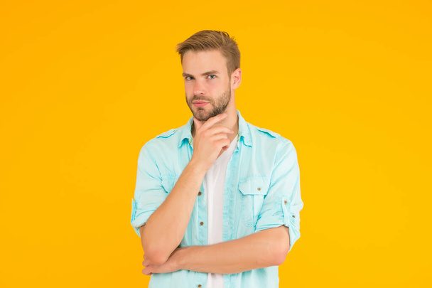 serious guy with bristle wear denim style outfit over yellow background, facial care - Foto, immagini