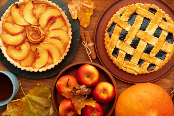 Thanksgiving berry and apple various pies on wooden surface, top view - 写真・画像