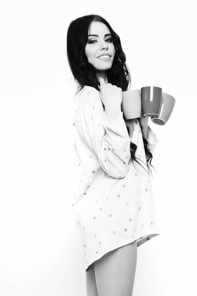 smiling pretty sexy girl with coffee cups isolated on white - 写真・画像