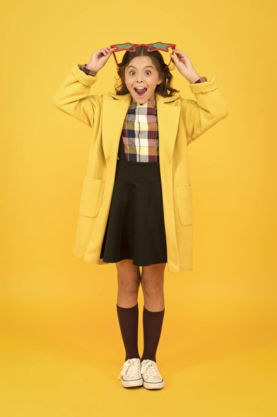 Perfect for school party. Happy party girl yellow background. Little kid wear party glasses with color lenses. Cute small child smile with party look. School holidays. Partying and celebrating - 写真・画像