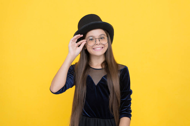 Accessorize and protect your eyesight. Happy child wear glasses yellow background. Corrective glasses for kids. Fashion eyewear. Eye protection. Childs vision correction. Optician salon - Zdjęcie, obraz
