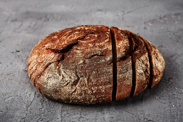 Bakery - gold rustic crusty loaves of bread and buns on grey chalkboard background. - Zdjęcie, obraz