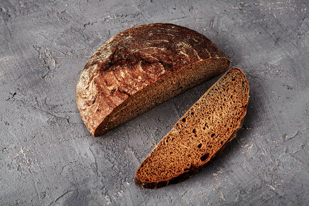 Bakery - gold rustic crusty loaves of bread and buns on grey chalkboard background. - 写真・画像