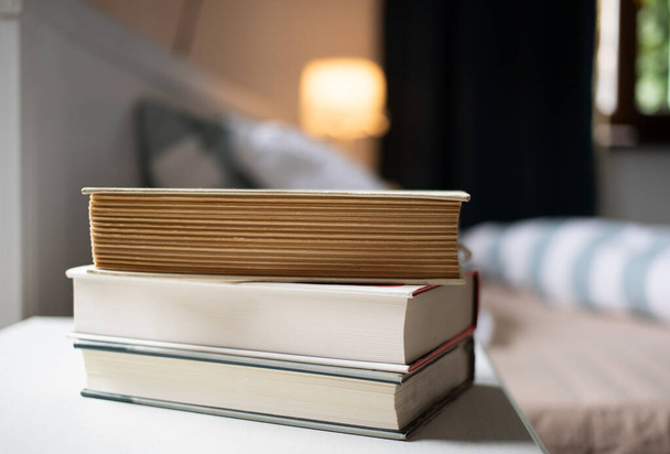 books on bedroom table by bed - Photo, Image