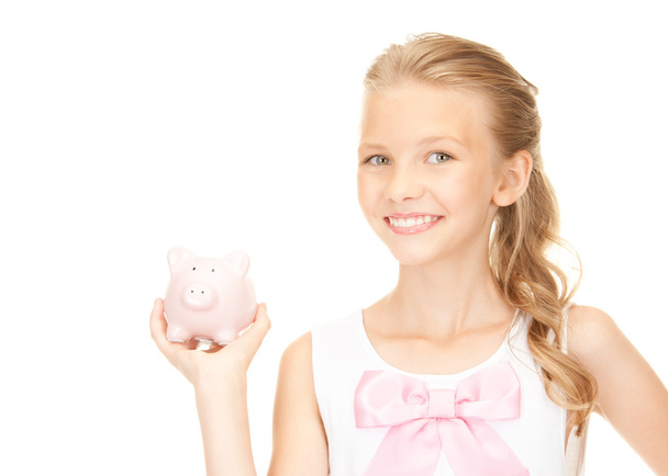 Lovely teenage girl with piggy bank - Foto, afbeelding