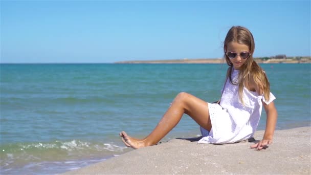 Adorable little girl have fun at tropical beach during vacation - Footage, Video