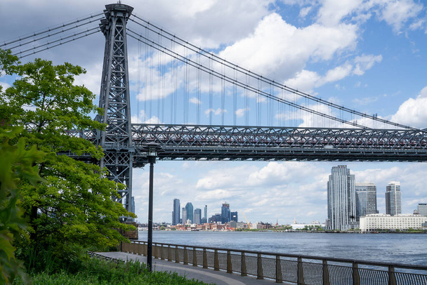 An empty promenade along East River in lower Manhattan with a view of Williamsburg Bridge - Photo, Image