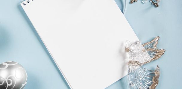 Christmas layout on a blue background. Flatley. Notebook. Close-up. Place for an inscription. - Foto, imagen