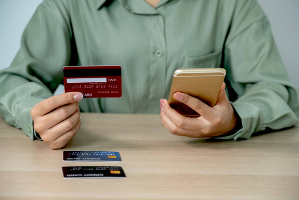 Bizneswoman trzymanie i używanie karty kredytowej do zakupów online z domu ze smartfonem, płatności e-commerce, bankowość internetowa, wydawanie pieniędzy na następne wakacje. - Zdjęcie, obraz
