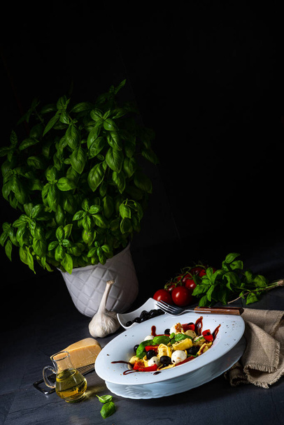 rustic tortellini pasta salad with mozzarella - 写真・画像