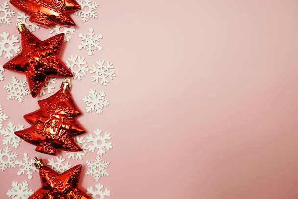 Composición laica plana con accesorios de decoración navideña sobre fondo rosa - Foto, imagen