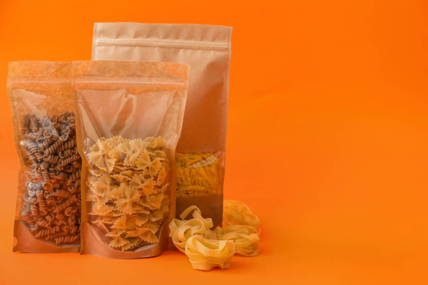 Bags with different pasta on color background - Foto, immagini