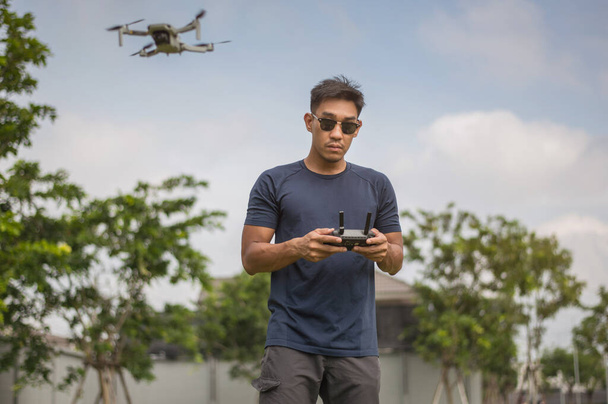 Drone pilot. Man using drone with remote controller. - Photo, Image