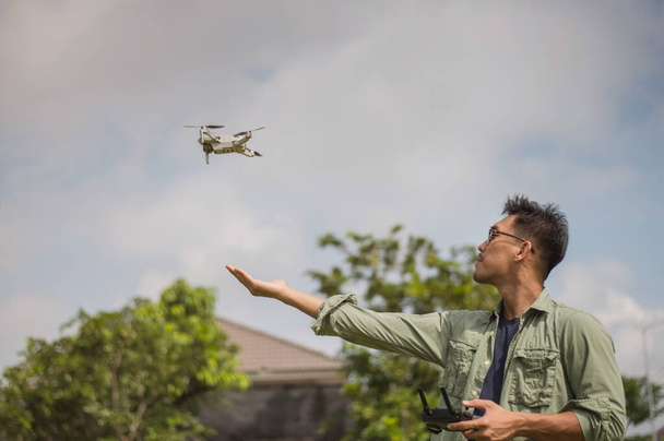 Man operating drone by remote control. Drone Pilot. - Photo, Image