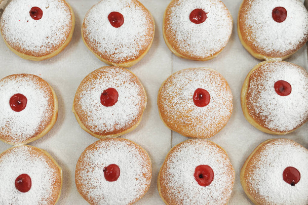 Hanukkah symbol jewish food holiday image of donut with jelly and sugar powders. - Photo, Image