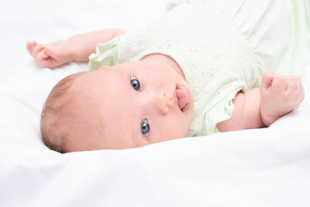 Portrait of a cute baby girl on a white background - Valokuva, kuva
