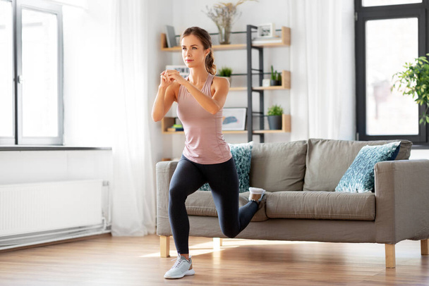 young woman exercising at home - Fotó, kép