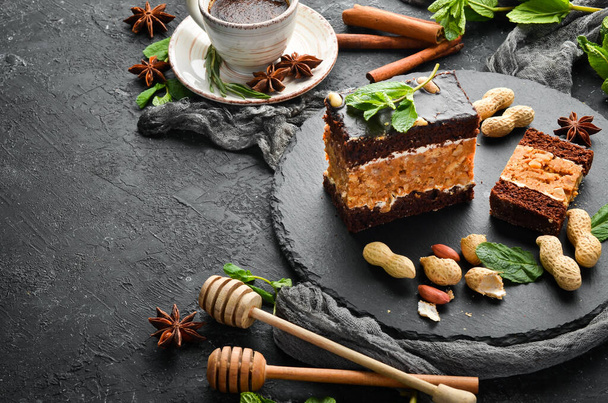 Peanut chocolate cake. Dessert. On a black background. Top view. - Fotó, kép