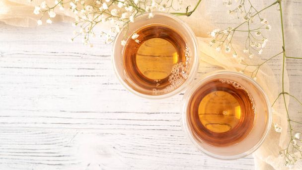 Summer tea on wooden table. Black tea in glass cups. Morning tea in mugs with place for text. Top view background - Photo, Image