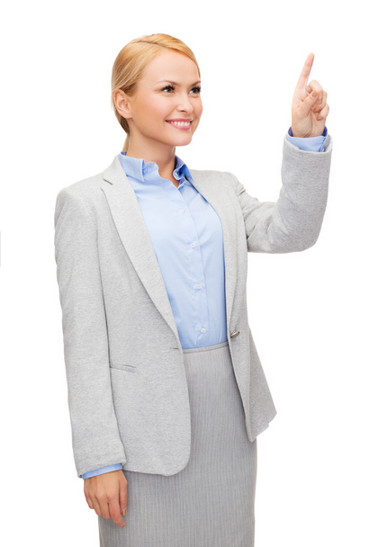 Smiling businesswoman working with virtual screen - Фото, изображение