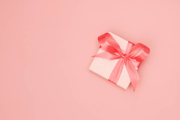 Pink christmas gift on pink background isolate, flatley, copy space - Photo, Image
