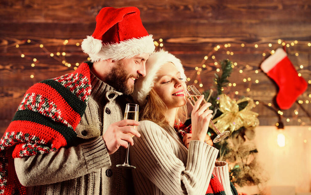 Pure feelings. woman and man love xmas. greeting time. Couple feeling cozy. happy new year. Holiday celebration. merry christmas. Family drink champagne. couple in love santa hat. Time for presents - 写真・画像