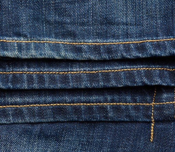 seam on blue jeans with brown thread, full frame, hem hem - 写真・画像