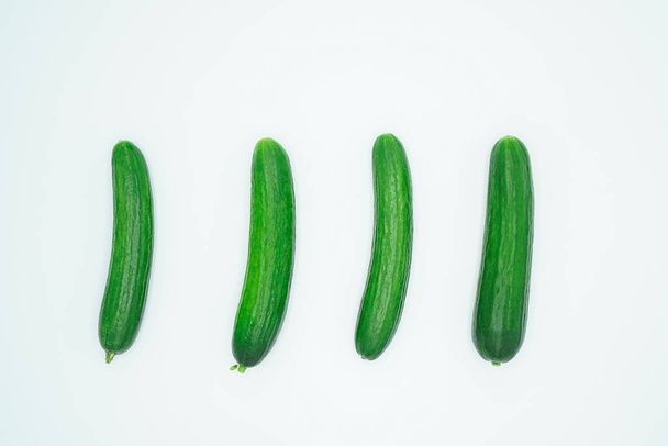 Close-up view of fresh cucumbers isolated on white background seen from top - Fotó, kép