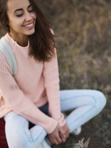 outdoor portrait woman in warm sweater sitting with closing eyes and enjoying nature in autumn - Photo, Image