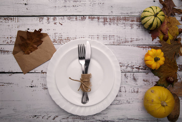 autumn composition with pumpkins and cutlery on an old table - Photo, Image