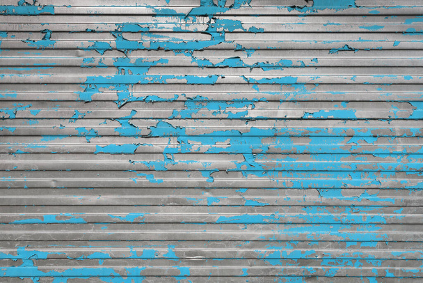 Peeling blue paint on the profiled iron surface. Detailed photo texture - Photo, Image