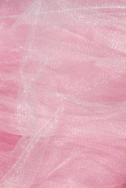 Pink tulle fabric texture top view. Coral background. Fashion color trends feminine tutu skirt flat lay, female blog backdrop for text signs desidgn. Girly abstract wallpaper, textile surface. - Photo, Image