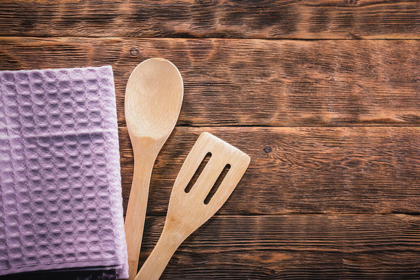 A kitchen towel and spatula on the kitchen table flat lay background with copy space. - Fotoğraf, Görsel