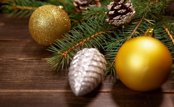 Christmas or New year dark wooden background, Christmas Board decorated with seasonal decorations and pine needles - Fotoğraf, Görsel
