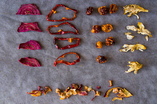 Dry vegetables on the table, red pepper, beet root, date and mushroom - Photo, Image