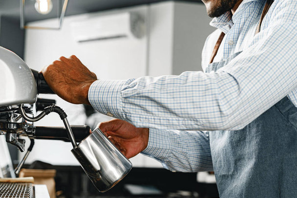 Unrecognizable man barista preparing coffee on professional coffee machine - Фото, изображение