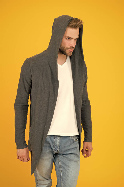 Comfy garment for daily life. Fashion man yellow background. Fashion look. Handsome guy wear fashionable mantle with hood. Casual wear for men. Fashion trends. Modern clothes for youth. Sporty style - Foto, afbeelding