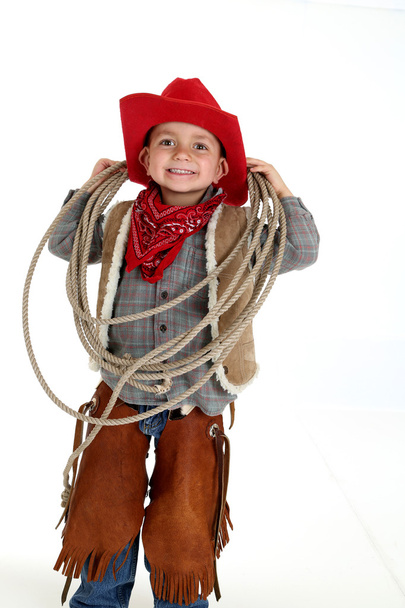 funny young cowboy with floppy ears smiling holding a rope - Φωτογραφία, εικόνα