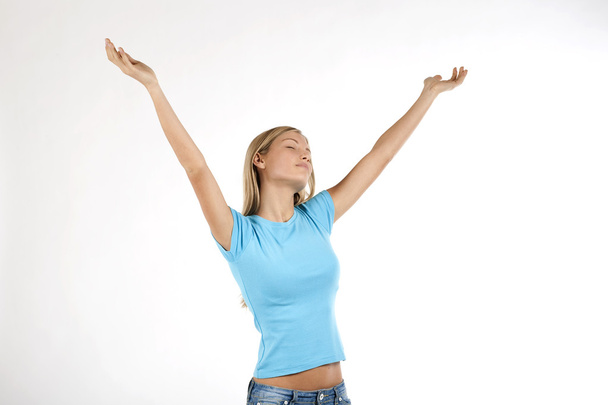 Beautiful young woman with arms raised - Foto, afbeelding