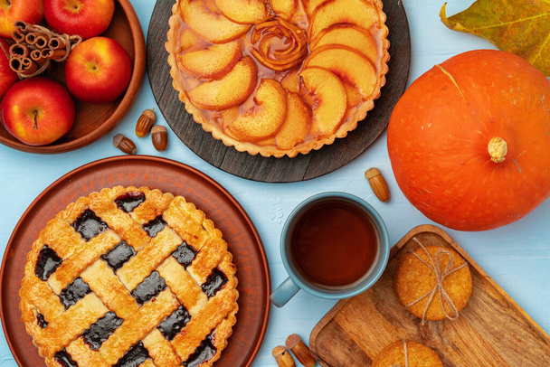 Thanksgiving berry and apple various pies on wooden surface, top view - 写真・画像