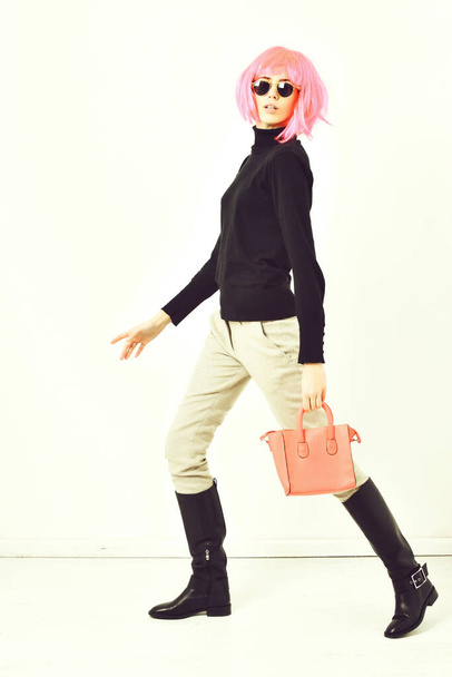 fashionable sexy girl in pink wig posing with fashion bag - Photo, Image