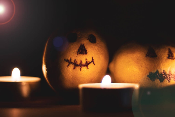 Halloween, Scary smiling drawing on a lemon in the dark - Photo, Image