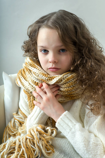Sad little girl sits alone. Allergy, illness, depression, stress or fatigue concept. - Fotó, kép