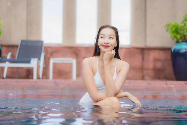 Portrait beautiful young asian woman relax smile leisure around outdoor swimming pool in hotel and resort - Foto, immagini